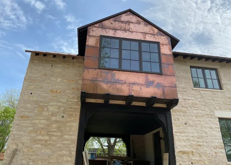 Copper metal panel facade on a stone building for Skylight Installation in DeBary