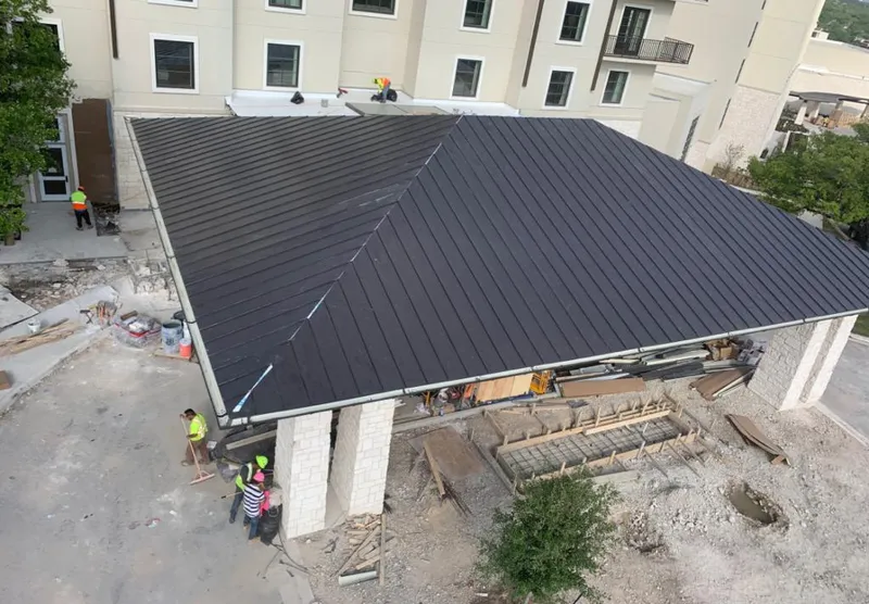 Metal roofing installation team working on a commercial building in DeBary